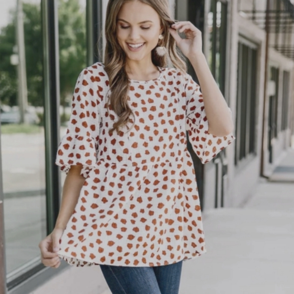 BOUTIQUE orange and cream peplum style top size large cow print